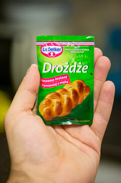 Vertical shot of a hand holding Dr. Oetker yeast pack