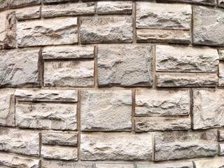 Textured stone wall with a rugged appearance offering ample space for design and text elements