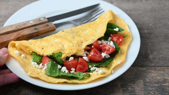  Stuffed omelette with tomatoes and spinach on wooden table video