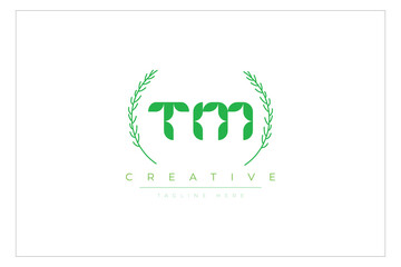 TM letters eco logo with leaf. Fresh nature and healthy leaf logo design.