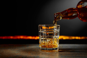 Whiskey is poured into a crystal glass.