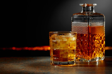 Whiskey with ice on a dark background.