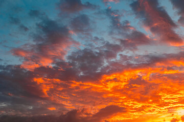 Vibrant sunset sky with orange clouds.