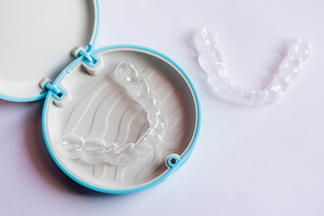 Clear aligner device in the mouth on a white background. (invisalign)