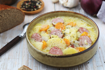 A bowl with traditional German potato soup with sausages	