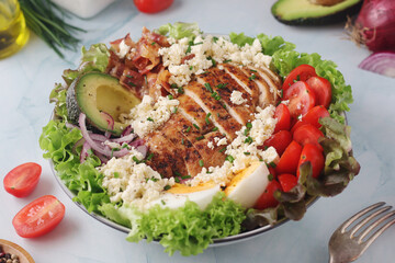 A bowl with cobb salad, traditional American dish