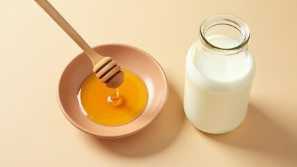 Top view of honey and milk. Honey pours from a wooden spoon into a brown plate. Milk in a glass bottle. Light beige background. Horizontal healthy breakfast concept