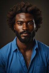 Fototapeta premium arafed man with a beard and a blue shirt looking at the camera