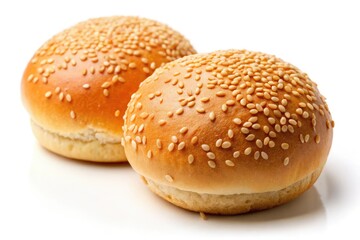 Close-up of golden sesame seed hamburger buns, isolated on white.  Bakery fresh, perfect for cooking.