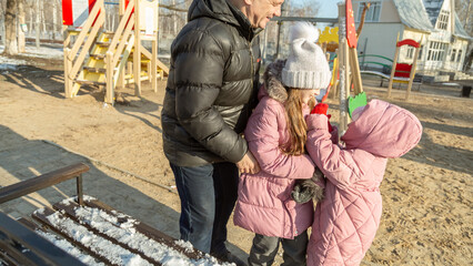 Little girl, quarreling and other crying during their walking in winter.