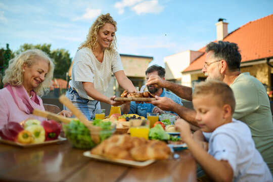 Happy family enjoying food at garden party