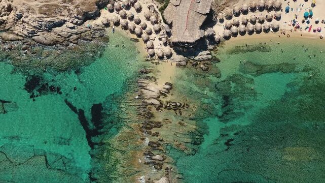 Aerial view of the blue sea water in Sithonia peninsula over Tigania Beach. Drone shot of a cape Tigania Beach Sithonia Greece.
