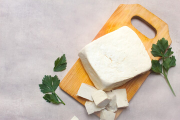 Slices of tofu made from soybeans on a cutting board