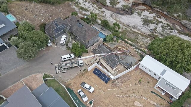 A truck delivers concrete to a building site on a river