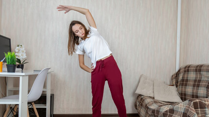 Young woman doing fitness exercise at home