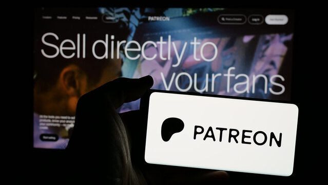 Stuttgart, Germany - 01-28-2025: Person holding mobile phone with logo of US monetization platform company Patreon Inc. on screen in front of web page. Focus on phone display.