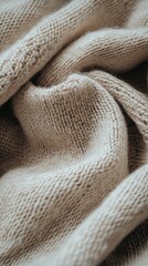 Soft beige sweater neatly folded on a clean surface, branding space.