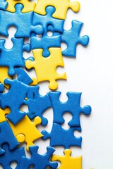 Obraz premium Photo of blue and yellow puzzle pieces on a white background, stock photo for a racing game. The top right corner is empty for text. There is white space at the bottom of the image. 