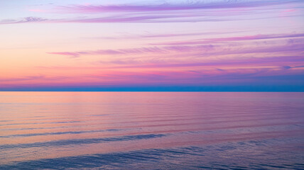 Obraz premium Serene Dawn Seascape with Soft Pink, Purple, and Blue Sky, Wispy Clouds, Tranquil Ocean Reflection, Gentle Waves, Clear Horizon, Peaceful Coastal Atmosphere, High-Resolution Scenic Background 