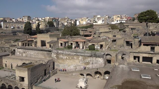 Italy tourism and landmarks, people visit Roman houses old ancient Herculaneum, a village that was covered in layers of volcanic rock and pumice in 79 AD
