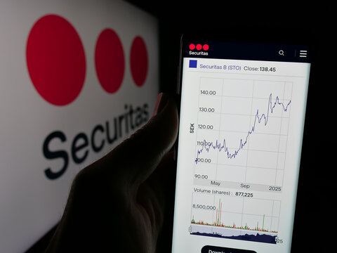 Stuttgart, Germany - 01-29-2025: Person holding smartphone with webpage of Swedish security service company Securitas AB on screen with logo. Focus on center of phone display.