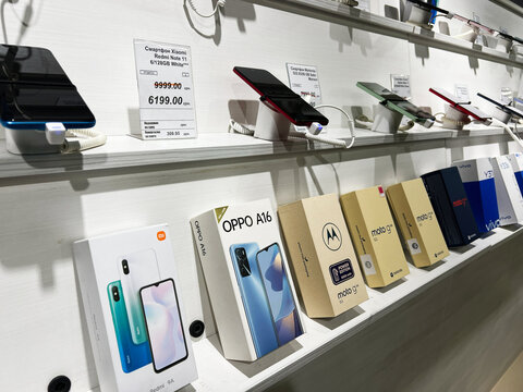 Kyiv, Ukraine - February 04, 2025: Selection of smartphones displayed for sale in a retail electronics store showroom