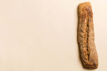 Minimalist french baguette on colored background. fresh bread as background, top view with space for your text or design