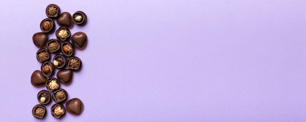 Different kinds of chocolates on colored table close-up. Top View and Flat Lay with copy space