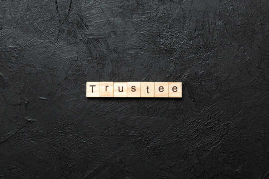 trustee word written on wood block. trustee text on table, concept