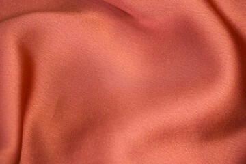 Shiny draped velour background. Wrinkled luxurious cloth background. Soft rose plush fabric with...