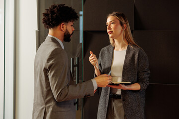 Employee talking to his manager in the hallway