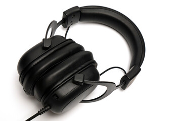 Black headphones in close-up on a white background, great music sound in a new headset, a new...