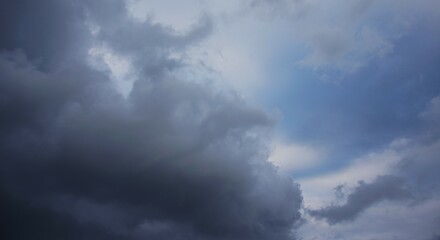 the afternoon sky is cloudy with black clouds, a sign that it will rain