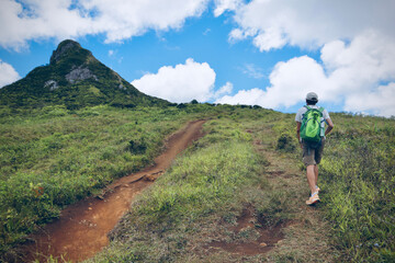 Fototapeta premium Man is hiking in mountains. Travel adventure during vacation, outdoor healthy lifestyle and eco tourism