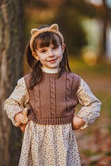 portrait of a little girl in the autumn park
