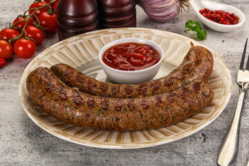 Grilled beef sausages with sauce
