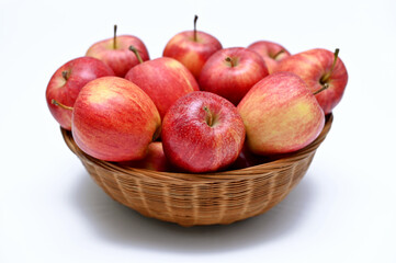 ripe red apples in a basket isolated on a white background