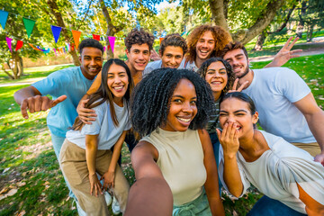 African young woman taking selfie in a park with friends