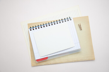 Office workspace with notebook, paper, small wooden clip. Flat lay, top view, business, work, mockup concept. copy space. Checklist, plan template.