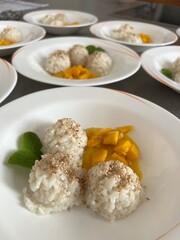 Coconut rice pudding elegantly served with mangoes.