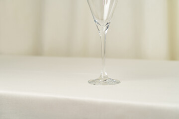 Empty wine glass on cream background