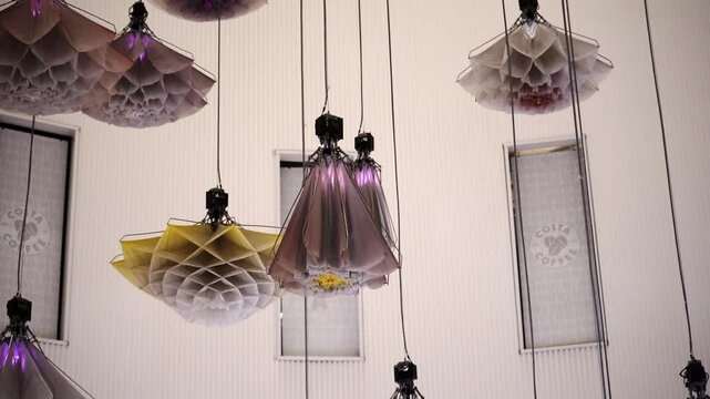 Artificial flowers mechanically opening and closing, symbolizing innovation, design, biomimicry, decorative technology, and modern creative engineering.