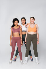 Obraz premium Empowering moments of strength and unity among fit women in stylish sportswear indoors