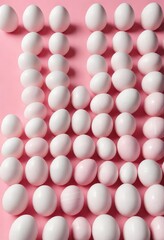 Pink and white Easter eggs arranged in rows over pink background, decoration, cheerful