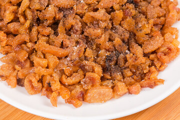 Duck сracklings with salt and pepper on dish close-up