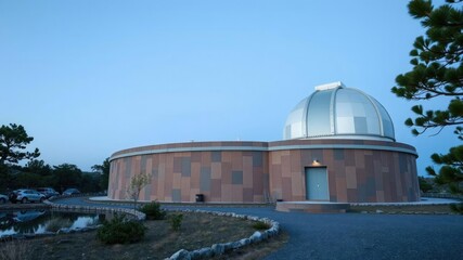 Fototapeta premium The observatory's exterior is camouflaged with a blend of earthy tones to minimize light pollution, architecture, universe