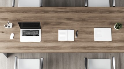 Top-down view of a corporate office workspace with laptops, documents, and an organized desk.