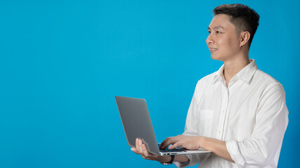 Confident young businessman in white shirt standing typing on laptop in various emotions
