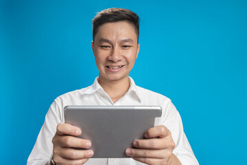 Confident young businessman in white shirt standing typing on an iPad in various emotions