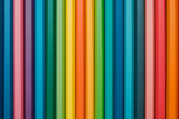 Obraz premium Vibrant rainbow colored pencils arranged in parallel lines, a spectrum of colors creating a visually appealing pattern, perfect for design and art-related projects 
